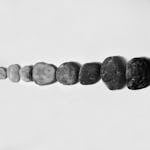 Row of Black and Gray Polished Pebble on Gray Surface